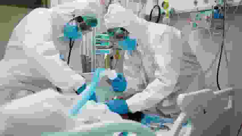 Doctors inserting ventilator