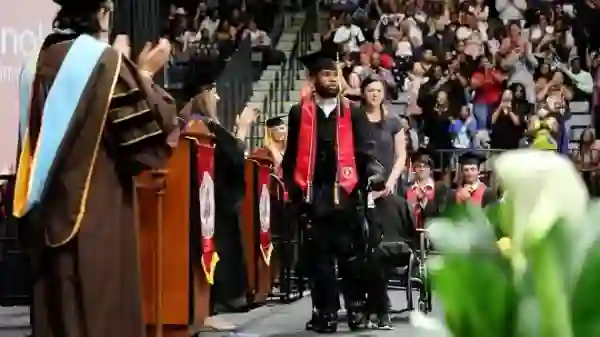 Paralyzed Student Walks At College Graduation [Photo: USA Today]