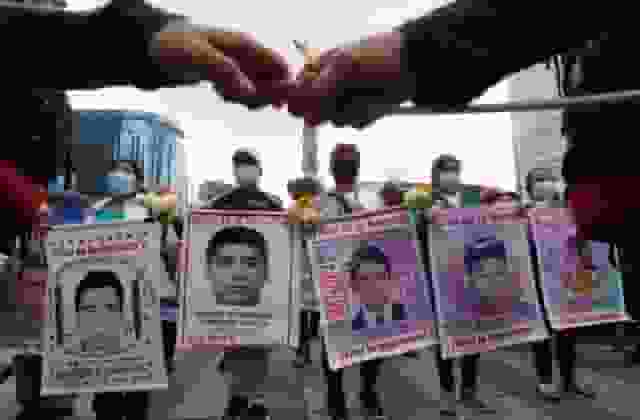 Relatives and classmates of the missing 43 Ayotzinapa college students march in Mexico City, Sept. 26, 2022, on the anniversary of their disappearance in Iguala, Guerrero state. (Photo: US News)